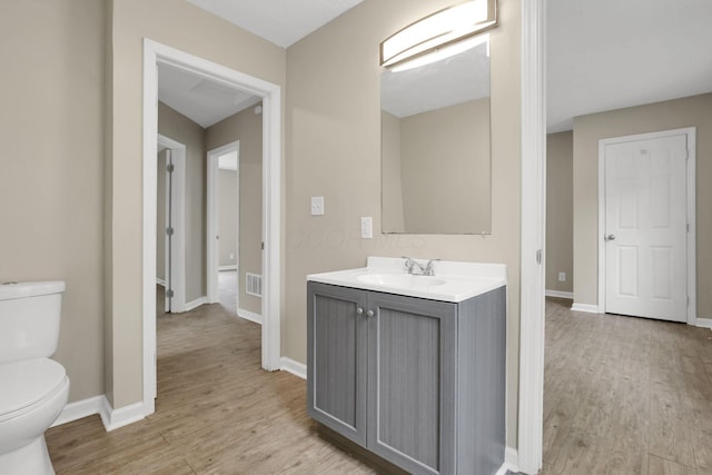1617 Arlington Ave, Columbus, OH 43211 - bathroom featuring wood finished floors, toilet, vanity, and baseboards