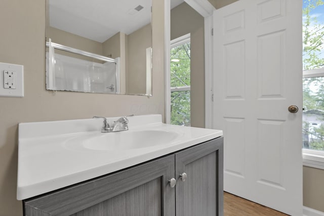 1617 Arlington Ave, Columbus, OH 43211 - full bath featuring vanity, plenty of natural light, a shower, and wood finished floors