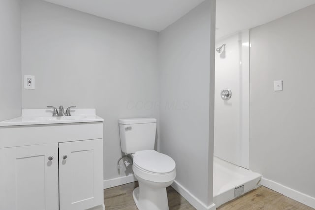 1617 Arlington Ave, Columbus, OH 43211 - bathroom with wood finished floors, toilet, a stall shower, and baseboards