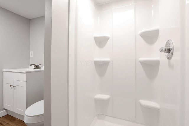 1617 Arlington Ave, Columbus, OH 43211 - bathroom featuring a shower, wood finished floors, vanity, and toilet