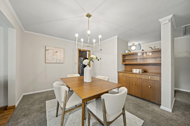 2249 E Broad St, Columbus, OH 43209 - carpeted dining space featuring crown molding, baseboards, and a chandelier