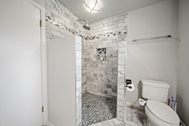 2249 E Broad St, Columbus, OH 43209 - bathroom featuring a tile shower, toilet, and baseboards