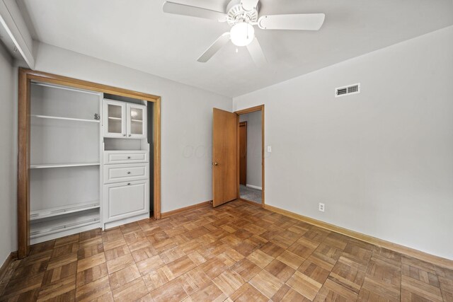 2249 E Broad St, Columbus, OH 43209 - unfurnished bedroom featuring baseboards, a closet, and a ceiling fan