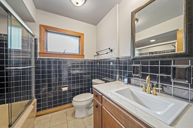 2249 E Broad St, Columbus, OH 43209 - bathroom with tile patterned flooring, plenty of natural light, tile walls, toilet, and shower / bath combination with glass door