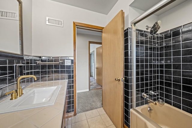 2249 E Broad St, Columbus, OH 43209 - full bathroom featuring tile patterned floors, tile walls, shower / bath combination, vanity, and wainscoting