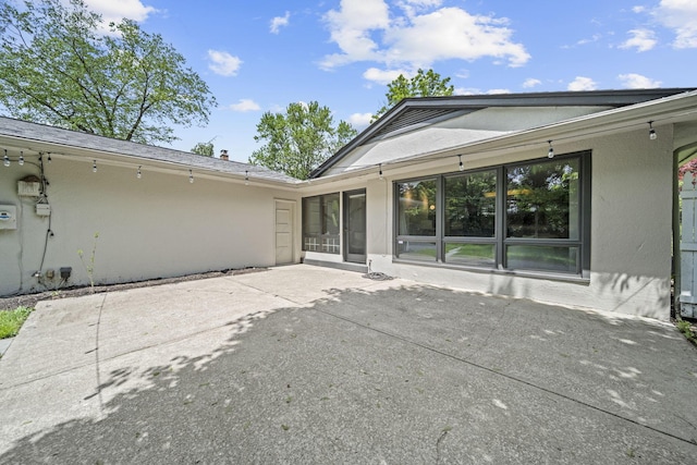 2249 E Broad St, Columbus, OH 43209 - rear view of house with stucco siding and a patio