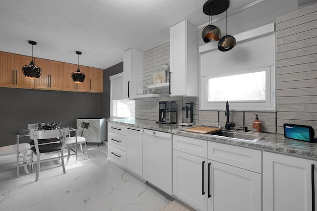3130 Marwick Rd, Columbus, OH 43232 - kitchen featuring white dishwasher, a sink, light marble finish floors, decorative backsplash, and white cabinetry