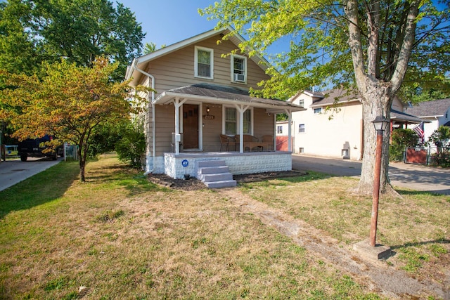 view of front of house with a porch and a front yard