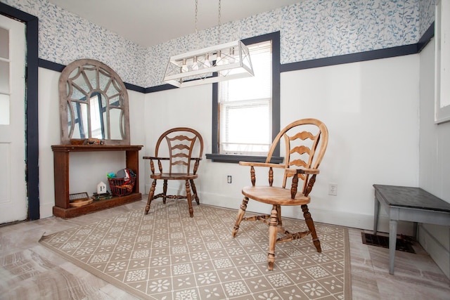 living area with wallpapered walls and baseboards