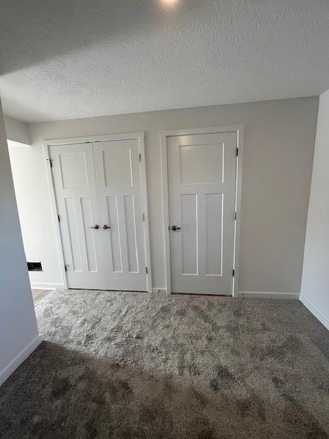 104 Red Willow Dr, Etna, OH 43068 - unfurnished bedroom featuring carpet flooring, baseboards, a textured ceiling, and a closet