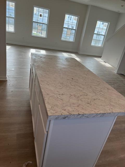 104 Red Willow Dr, Etna, OH 43068 - kitchen featuring wood finished floors, white cabinetry, baseboards, and open floor plan