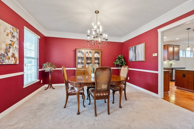 6674 Letterman Dr, Powell, OH 43065 - dining room featuring healthy amount of natural light, a chandelier, light colored carpet, and crown molding