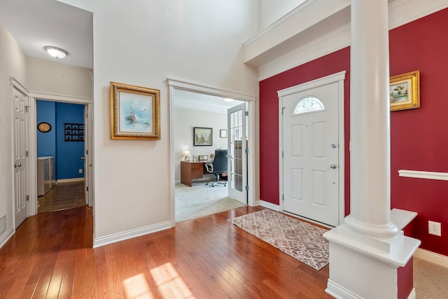 6674 Letterman Dr, Powell, OH 43065 - foyer entrance with hardwood / wood-style floors, baseboards, washer / clothes dryer, and decorative columns