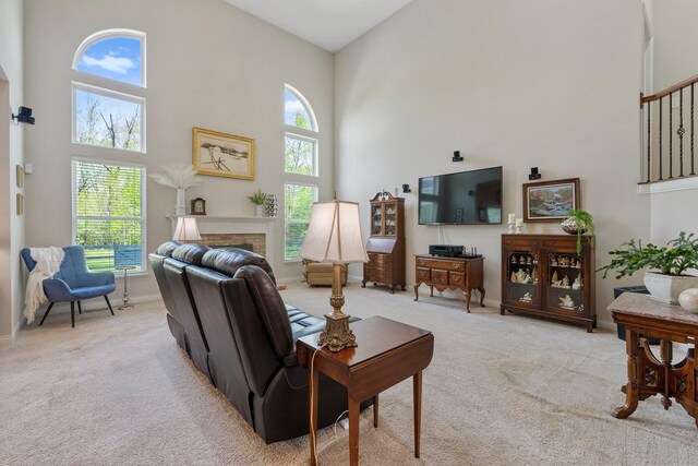 6674 Letterman Dr, Powell, OH 43065 - living room featuring a towering ceiling, light carpet, baseboards, and a fireplace