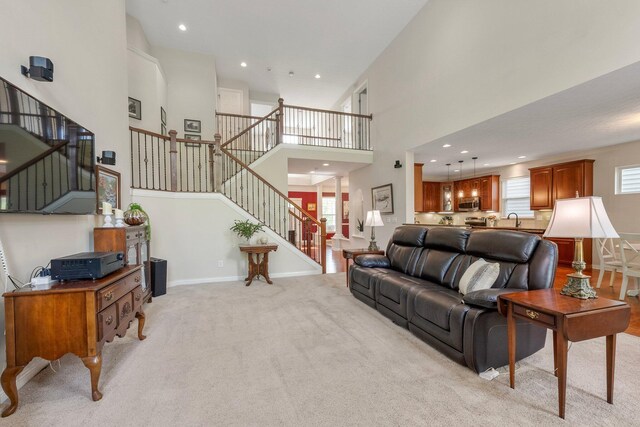 6674 Letterman Dr, Powell, OH 43065 - living room featuring a high ceiling, plenty of natural light, light carpet, stairs, and recessed lighting