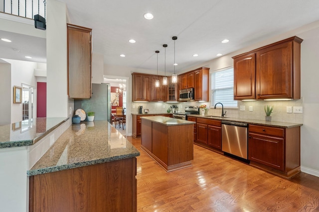 6674 Letterman Dr, Powell, OH 43065 - kitchen with appliances with stainless steel finishes, a sink, a peninsula, decorative backsplash, and recessed lighting