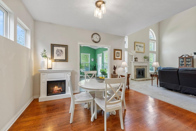 6674 Letterman Dr, Powell, OH 43065 - dining area featuring a glass covered fireplace, healthy amount of natural light, and wood finished floors
