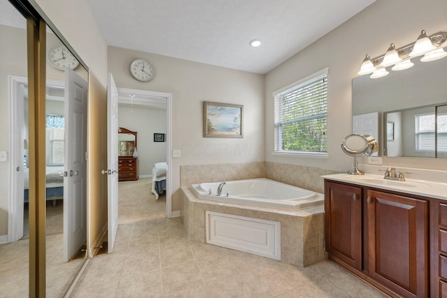6674 Letterman Dr, Powell, OH 43065 - full bathroom with connected bathroom, a garden tub, vanity, tile patterned flooring, and recessed lighting