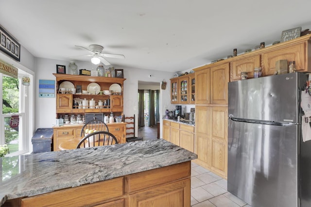 1525 Krebs Dr, Newark, OH 43055 - kitchen with freestanding refrigerator, open shelves, a ceiling fan, glass insert cabinets, and light tile patterned flooring