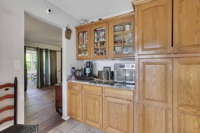 1525 Krebs Dr, Newark, OH 43055 - kitchen featuring glass insert cabinets and light wood-style flooring