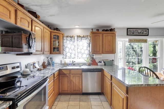 1525 Krebs Dr, Newark, OH 43055 - kitchen featuring stainless steel appliances, a peninsula, glass insert cabinets, and light stone countertops