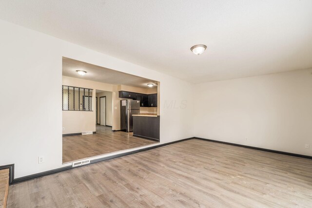 2594 Hubbell Rd, Columbus, OH 43232 - unfurnished living room featuring light wood-type flooring and baseboards
