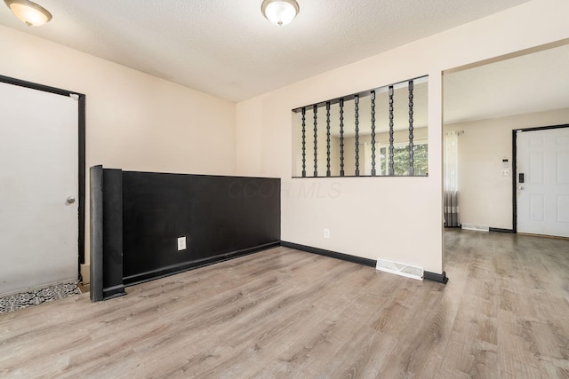 2594 Hubbell Rd, Columbus, OH 43232 - unfurnished room featuring wood finished floors, baseboards, and a textured ceiling