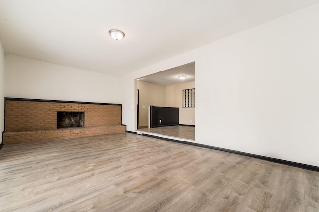 2594 Hubbell Rd, Columbus, OH 43232 - unfurnished living room featuring wood finished floors, a fireplace, and baseboards