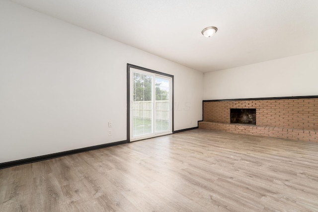 2594 Hubbell Rd, Columbus, OH 43232 - unfurnished living room with wood finished floors, a fireplace, and baseboards