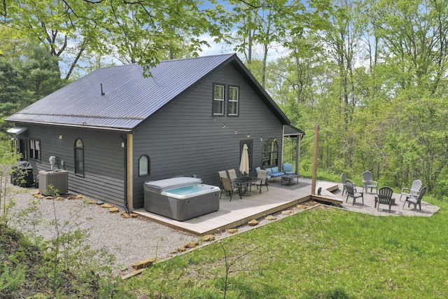 28306 Allison Rd, Mcarthur, OH 45651 - rear view of property featuring a deck, an outdoor living space with a fire pit, central AC, metal roof, and a yard