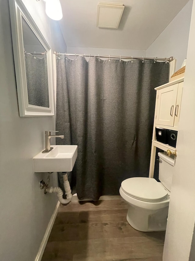 1985 Sedan Ave, Obetz, OH 43207 - bathroom with wood finished floors, toilet, a shower with curtain, and a sink
