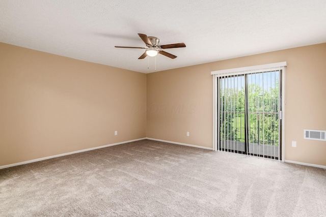 carpeted spare room with ceiling fan and baseboards