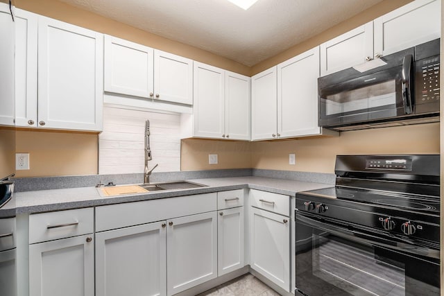 kitchen featuring black appliances, a sink, white cabinetry, backsplash, and a textured ceiling