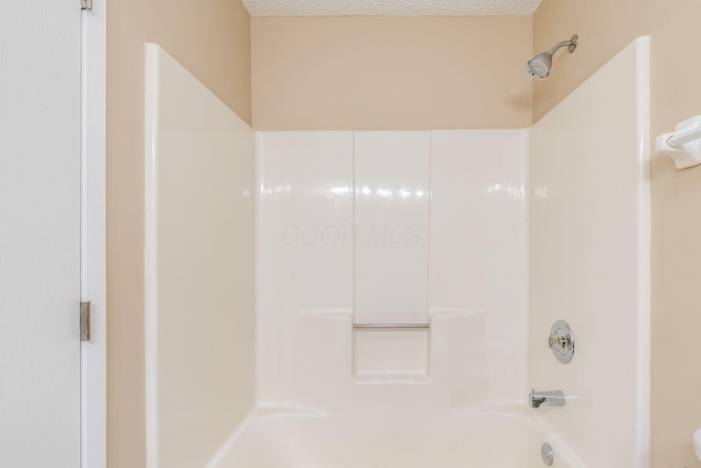 bathroom with shower / washtub combination