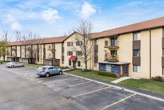 view of apartment building / complex with uncovered parking