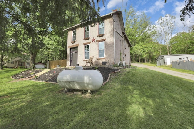 998 Wayne Ave, Zanesville, OH 43701 - view of front of house featuring brick siding, a chimney, and an outdoor structure