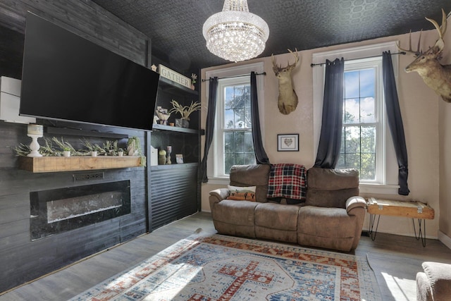998 Wayne Ave, Zanesville, OH 43701 - living room featuring a chandelier, an ornate ceiling, wood finished floors, a fireplace, and baseboards