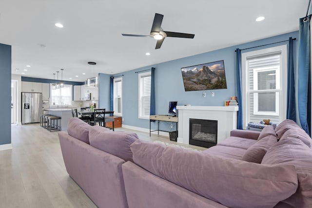 1242 N Grant Ave, Columbus, OH 43201 - living area featuring a ceiling fan, recessed lighting, light wood-style flooring, baseboards, and a glass covered fireplace