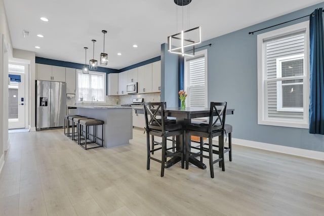 1242 N Grant Ave, Columbus, OH 43201 - dining area with light wood-style floors, recessed lighting, and baseboards