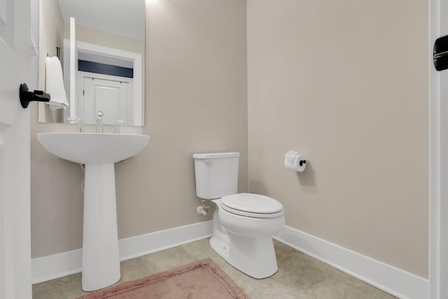 1242 N Grant Ave, Columbus, OH 43201 - bathroom featuring toilet, baseboards, and tile patterned floors
