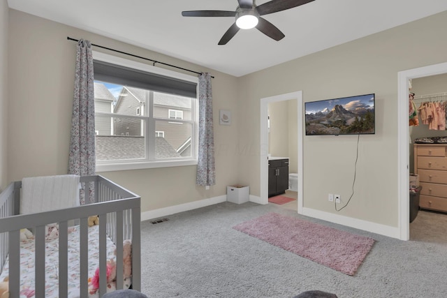 1242 N Grant Ave, Columbus, OH 43201 - bedroom with a walk in closet, light colored carpet, a closet, baseboards, and ceiling fan