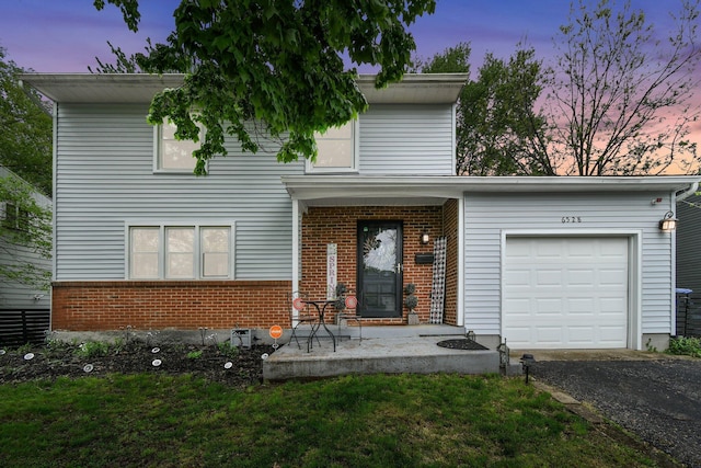 6528 Shenandoah Dr, Reynoldsburg, OH 43068 - view of front facade featuring brick siding, an attached garage, asphalt driveway, and a lawn