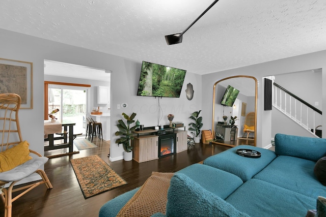 6528 Shenandoah Dr, Reynoldsburg, OH 43068 - living room featuring wood finished floors, a textured ceiling, and stairway