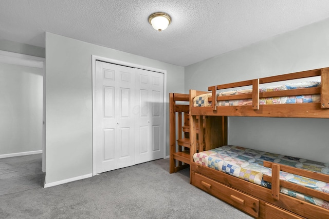 12164 Twincreek Dr, Pickerington, OH 43147 - carpeted bedroom with a textured ceiling, a closet, and baseboards