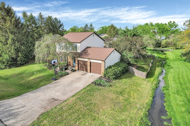 12164 Twincreek Dr, Pickerington, OH 43147 - view of front facade featuring driveway, brick siding, roof with shingles, a garage, and view of wooded area