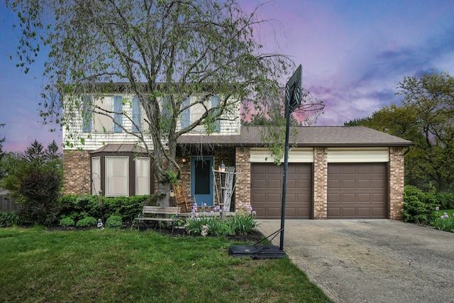 12164 Twincreek Dr, Pickerington, OH 43147 - view of front of property featuring driveway, an attached garage, brick siding, and a yard
