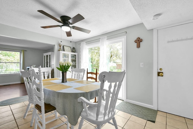 12164 Twincreek Dr, Pickerington, OH 43147 - dining room featuring healthy amount of natural light, a textured ceiling, ceiling fan, light tile patterned flooring, and baseboards