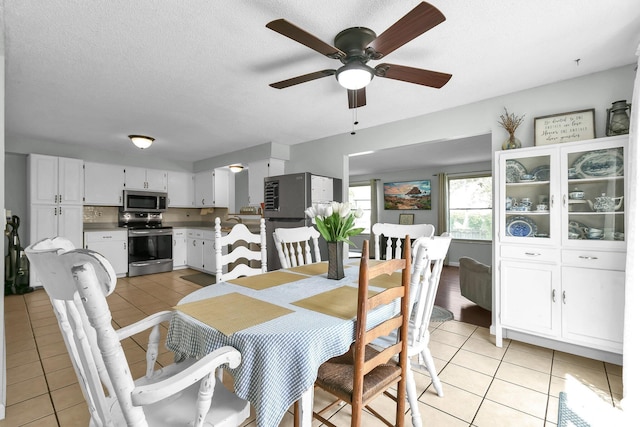 12164 Twincreek Dr, Pickerington, OH 43147 - dining area with light tile patterned flooring, a ceiling fan, and a textured ceiling