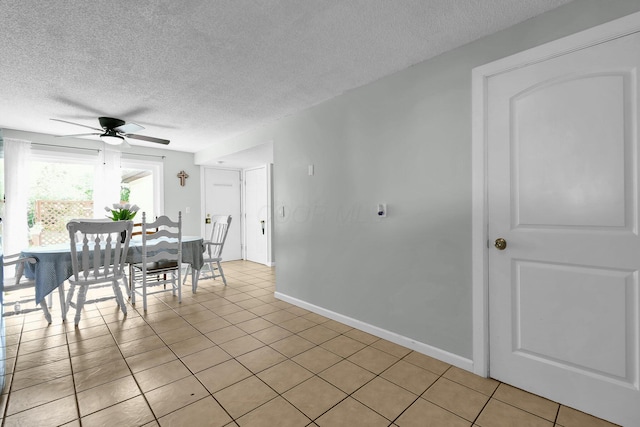 12164 Twincreek Dr, Pickerington, OH 43147 - dining area with a textured ceiling, ceiling fan, light tile patterned floors, and baseboards