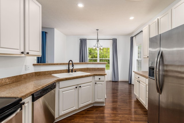 9162 Scenic View Cir, Columbus, OH 43240 - kitchen with stainless steel appliances, a sink, dark wood-style flooring, white cabinets, and a peninsula